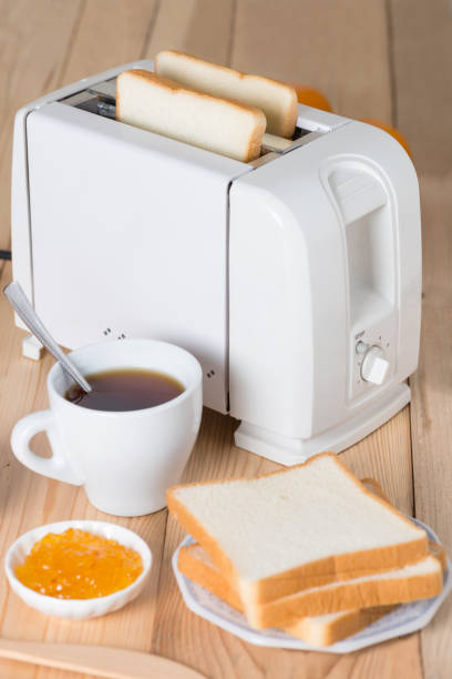 istock Toaster with sandwiches and jam on a kitchen table. 687881180