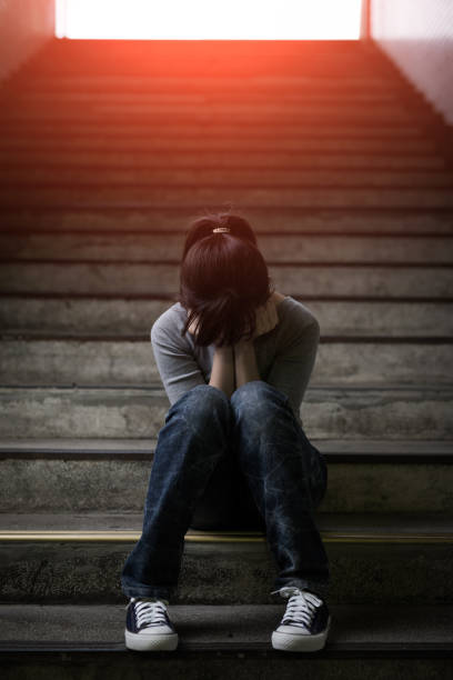 istock depressed woman in underground 687884274