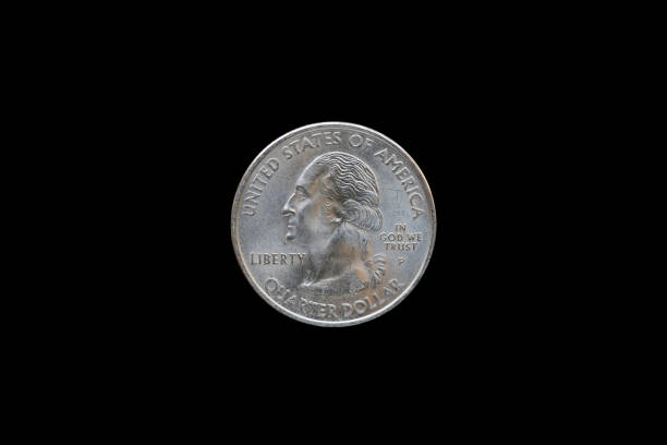 istock Twenty five American cents (Quarter Dollar) isolated on black background. 687886276