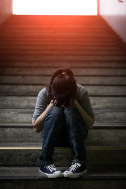 istock depressed woman in underground 687886424