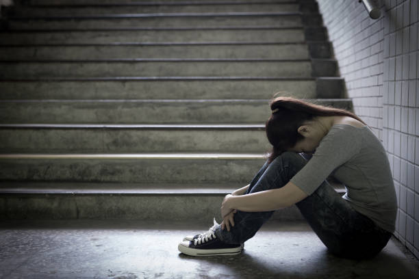 istock depressed woman in underground 687892606
