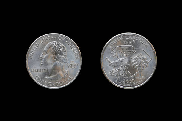 istock Twenty five American cents (Quarter Dollar) isolated on black background. 687893542