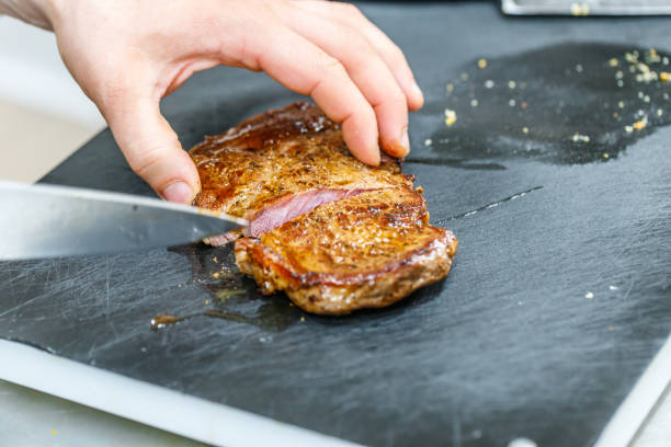 istock The cook cuts fried pork meat 687894266