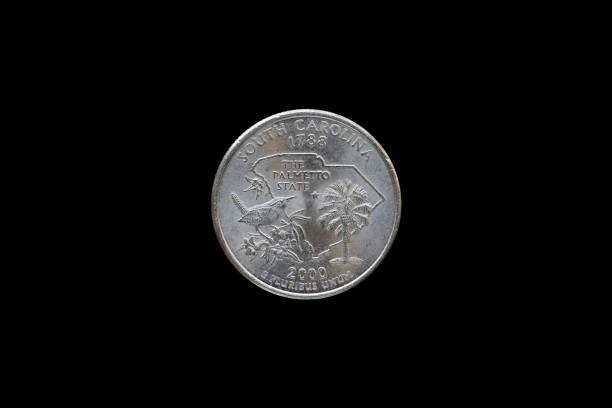 istock Twenty five American cents (Quarter Dollar) isolated on black background. 687897014