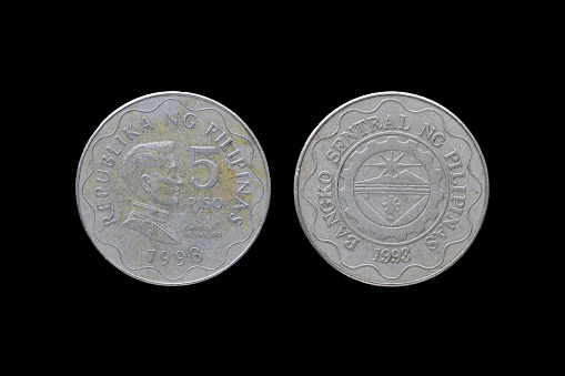 Philippine coins isolated on black background.