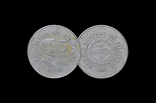 Philippine coins isolated on black background.