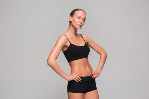 istock Muscular young woman athlete on gray 687904870