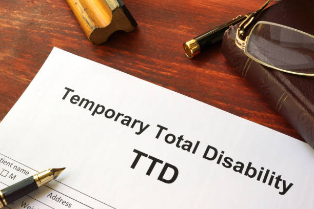 Temporary Total Disability (TTD) form on a wooden table. Temporary Total Disability (TTD) form on a wooden table. temporary stock pictures, royalty-free photos & images