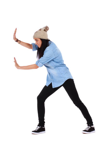 Woman pushing something imaginary over white stock photo