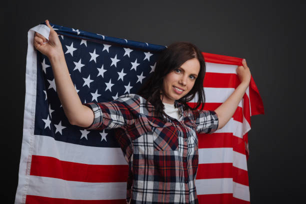 istock Loyal citizen holding up the national flag 687924310