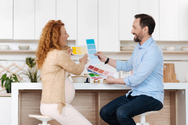 istock Husband and wife laughing out loud in kitchen 687929012