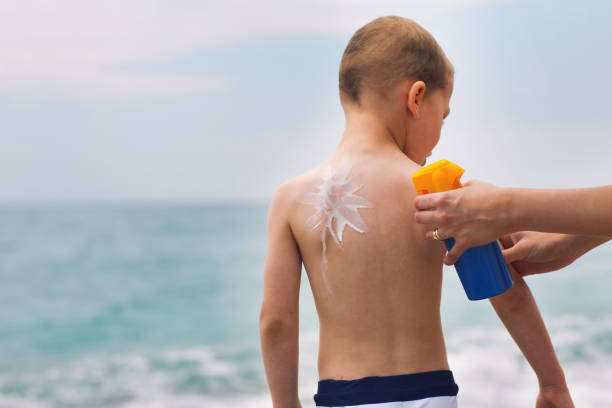 istock Parent applying sunblock cream on child shoulder 687931902