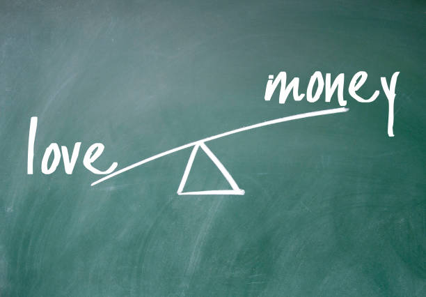istock love and money seesaw 687932364