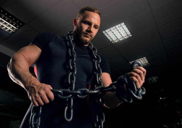 istock Professional powerlifter stands in the gym with iron chains 687939426