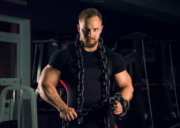 istock Strong athlete is wearing bench equipment with a chain around his neck 687939434