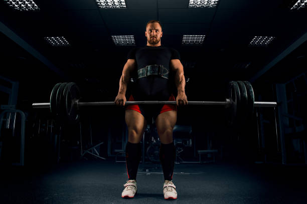 istock Athlete makes a deadlift. He fixed the bar at the top 687939506