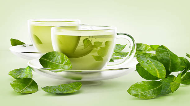 copas de cristal con té verde y té hojas aisladas en blanco - té verde fotografías e imágenes de stock