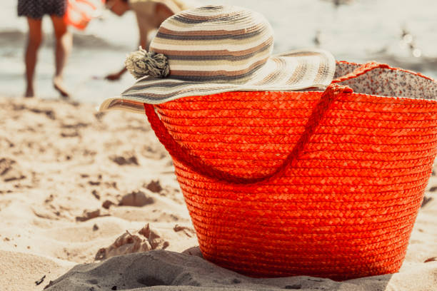 istock Wicker basket handbag bag and hat on summer beach. 687939674