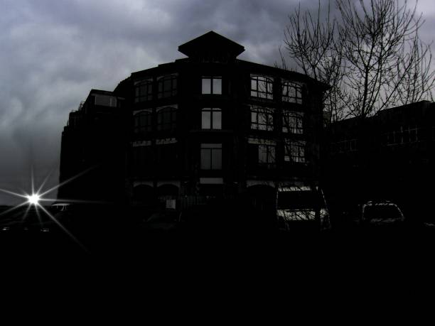 An old dark ghost mansion, just a secund before the sun goes down with many abandoned cars with no drivers, parked in front,supposively people came to visit the house and never left , vintage vignette applied