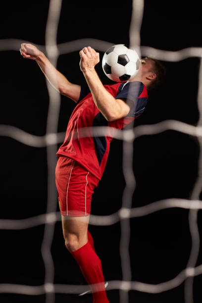 istock Professional Soccer Player Controlling Ball In Studio 687946456