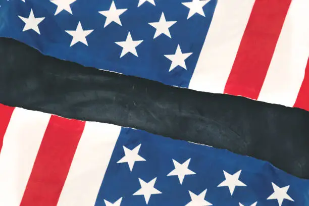 Top view of two American flags made out of paper on the blackboard