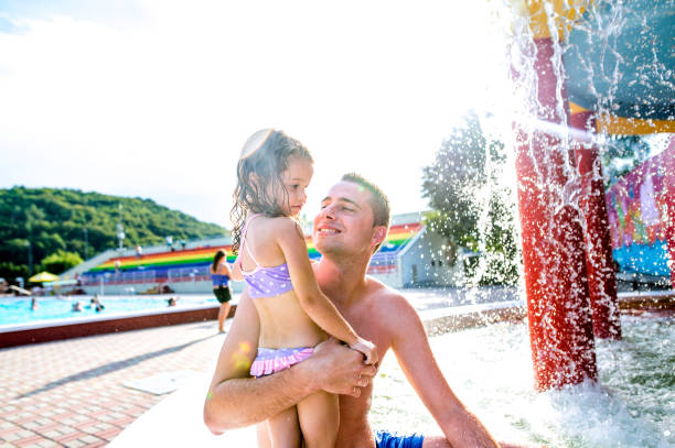 istock Father with his daughter in swimming pool. Sunny summer. 687949782