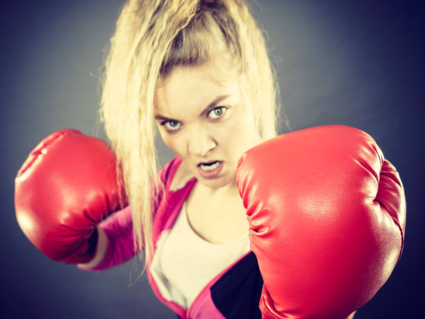 istock Angry woman wearing boxing gloves 687949784
