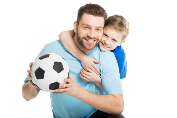 istock Young father and son posing with soccer ball isolated on white 687951470