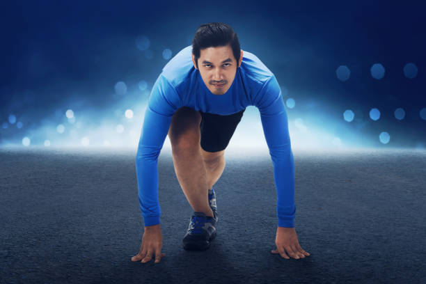 istock Runner asian man with hands on starting line ready to sprint 687957978