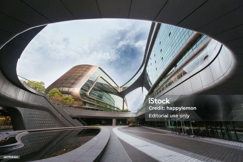 Modern futuristic architecture office building designed by Zaha Hadid Shanghai, China - April 19, 2017: Soho Hongqiao building in Shanghai. Modern futuristic architecture office building designed by Zaha Hadid Zaha Hadid Stock Photo