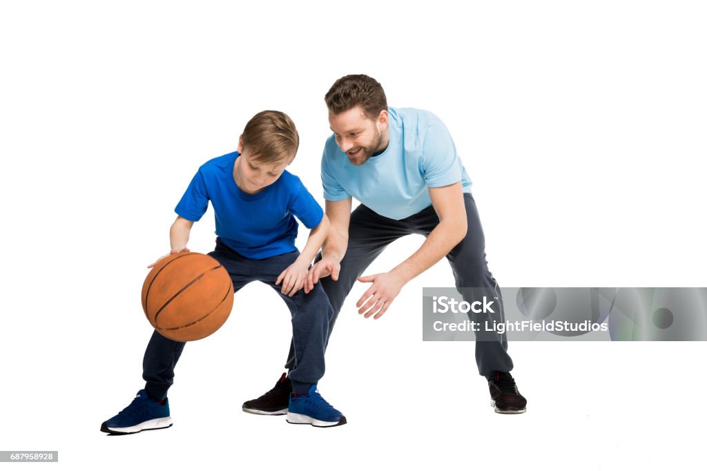 Father with son in casual clothes playing basketball isolated on white Basketball - Sport Stock Photo