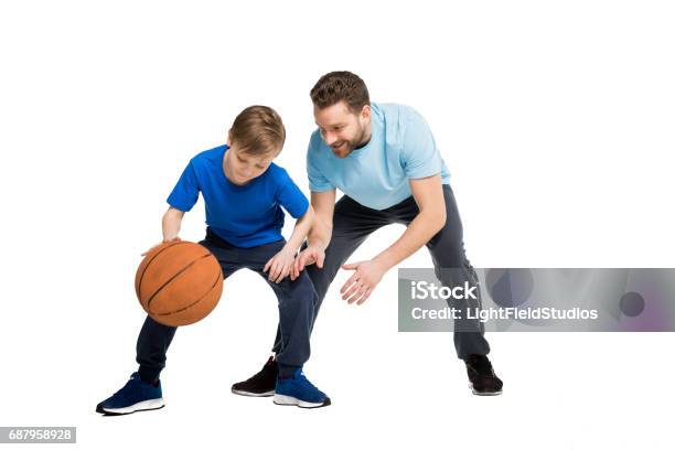 Father With Son In Casual Clothes Playing Basketball Isolated On White Stock Photo - Download Image Now