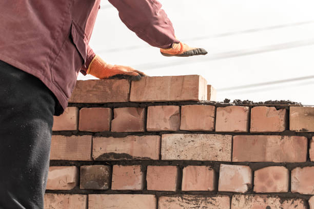 istock Worker builds a brick wall in the house 687965058