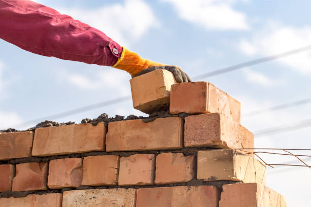 istock Worker builds a brick wall in the house 687965408