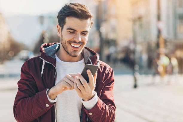 istock Young man dialing on the street 687965530