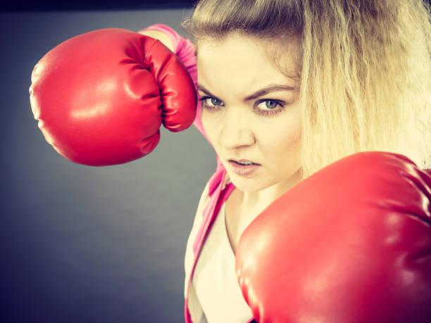 istock Angry woman wearing boxing gloves 687971542