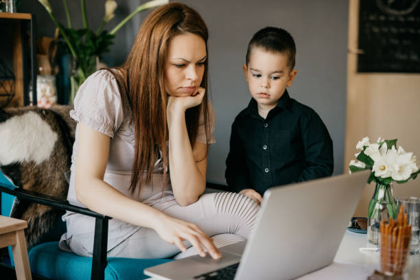 istock Mother and son using a laptop at home 687972084