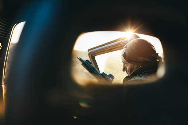 Soldier in back of vehicle