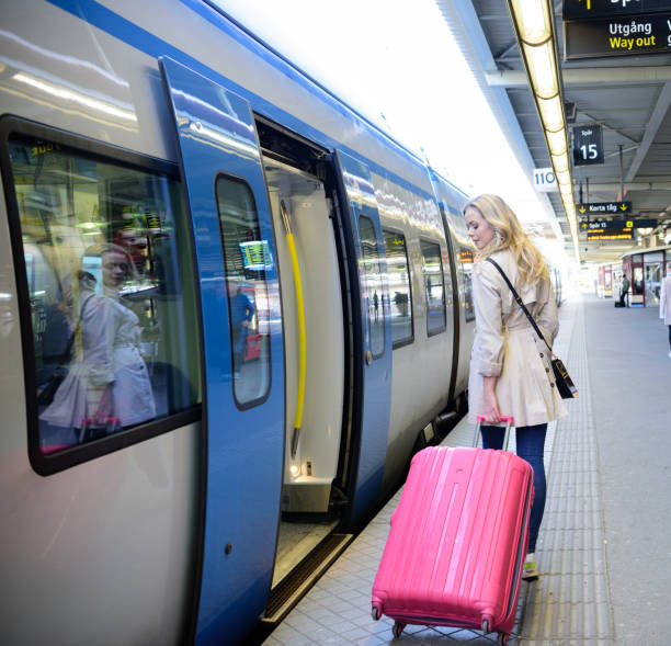 Blonde Swedish woman exiting commuter subway train
