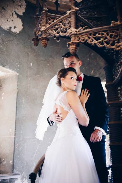 istock Young Bride and Groom on old stairs. Wedding day. Wedding session 687975990