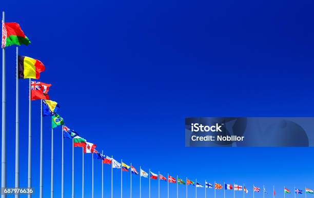Flags Against Blue Sky Stock Photo - Download Image Now - United Nations, National Flag, Flag