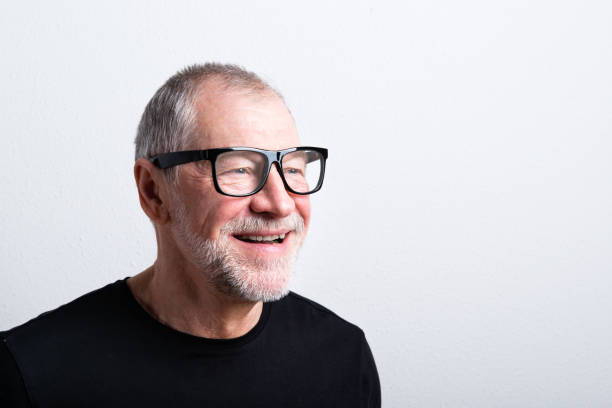 istock Senior man in black t-shirt and eyeglasses, studio shot. 687976802