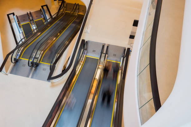 istock escalator with person movemont in blur from high Angle view 687981420