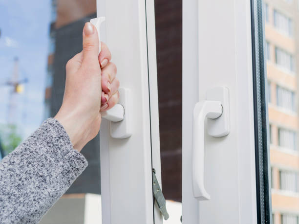 istock Woman's hand opening a window. Ventilating a house in hot weather. 687987358