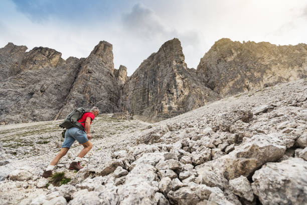 istock Senior man trail hiking on the Alps 687989230