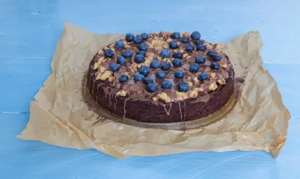 Chocolate tart with peanut caramel and blueberries.