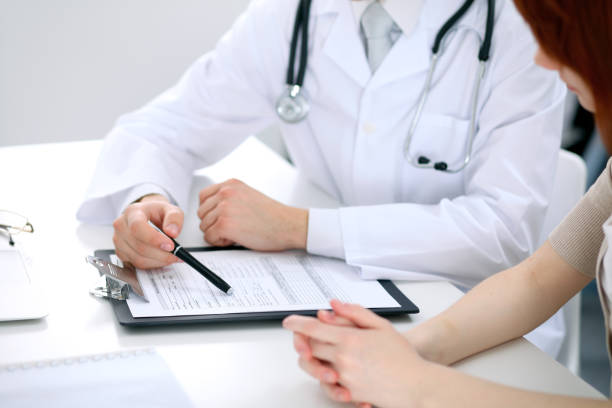 istock Doctor and patient are discussing something, just hands at the table 687994452