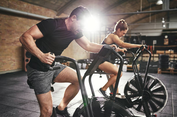 istock Man and woman riding fast on simulators 687994684