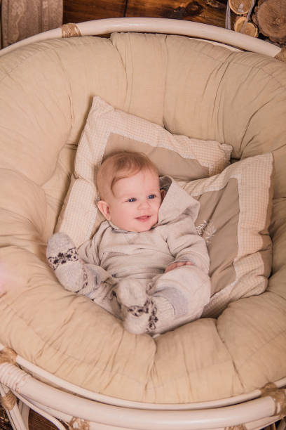 istock A small child in a large round chair 687998062
