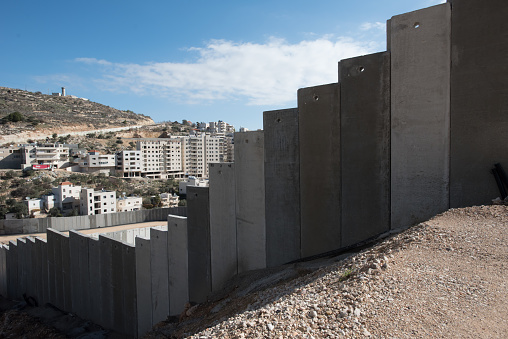 The Israeli Separation Wall divides land belonging to the West Bank village of Beit Jala, December 30, 2016.